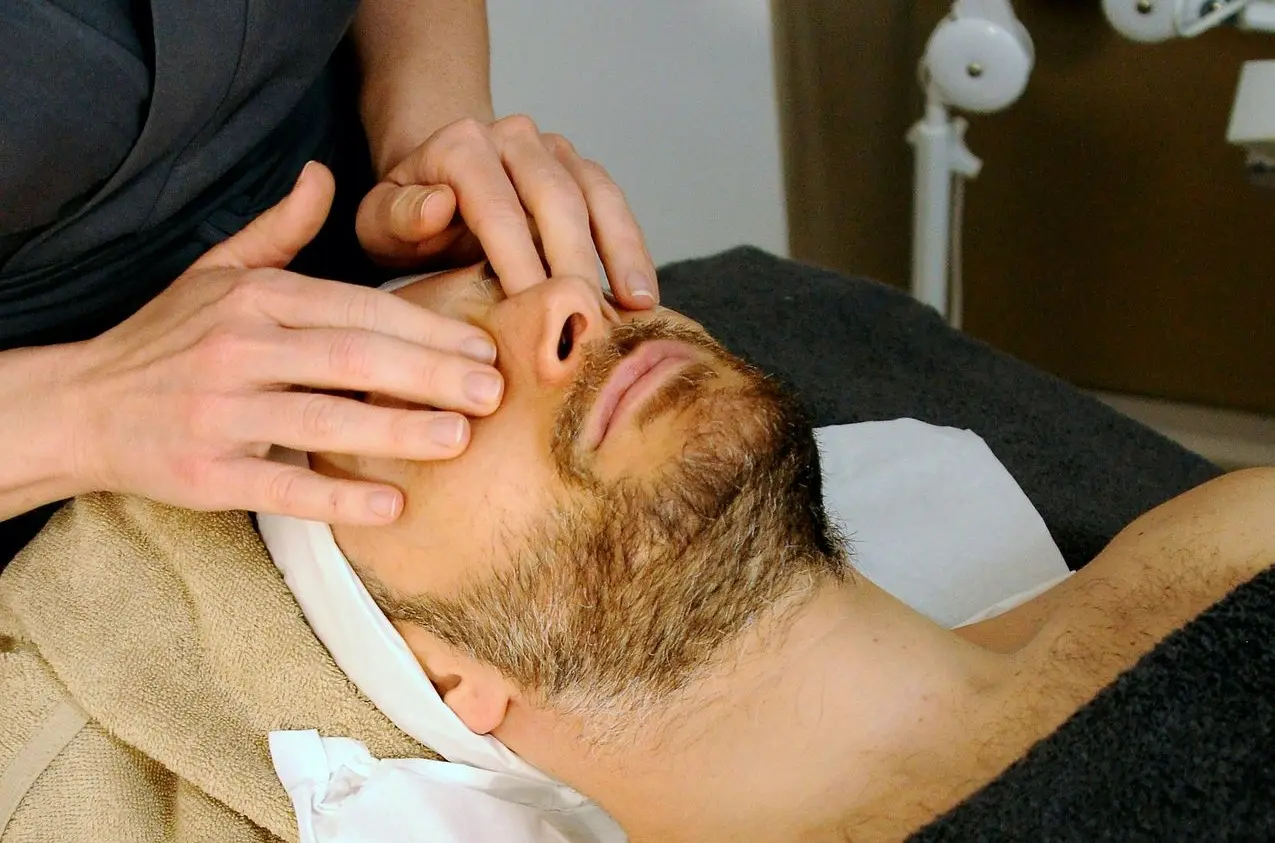 sleeping man while having massage